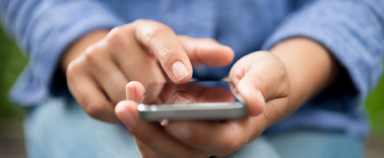 blue shirt woman using phone