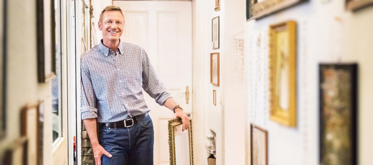 caucasian man smiling about valuable posessions