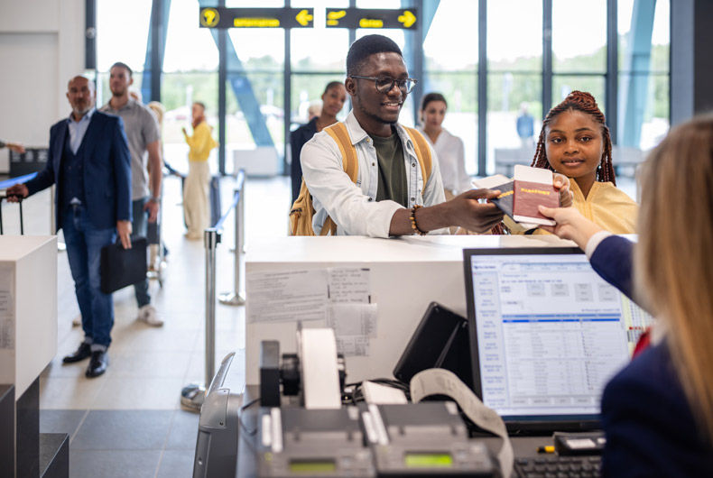 Couple checking in for a flight at an airport counter