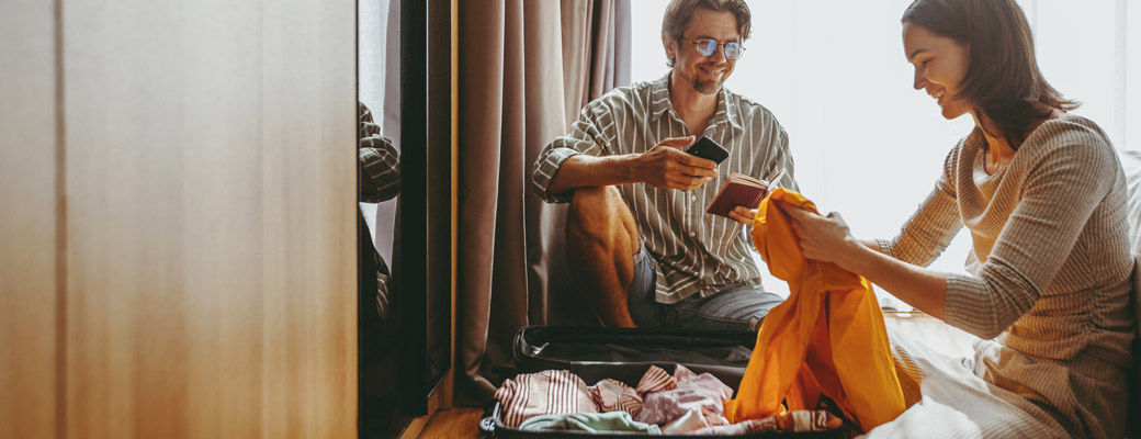 Couple packing a suitcase together before a trip