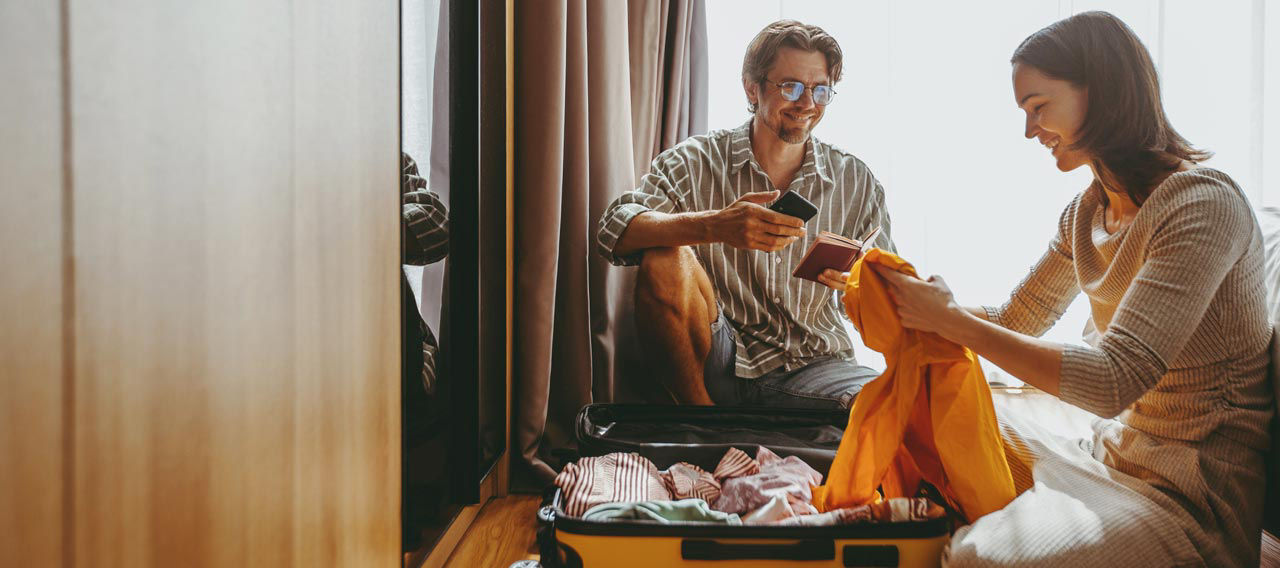 Couple packing a suitcase together before a trip
