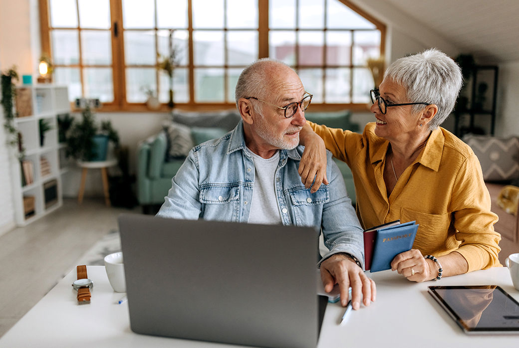 Older couple using a laptop together at home