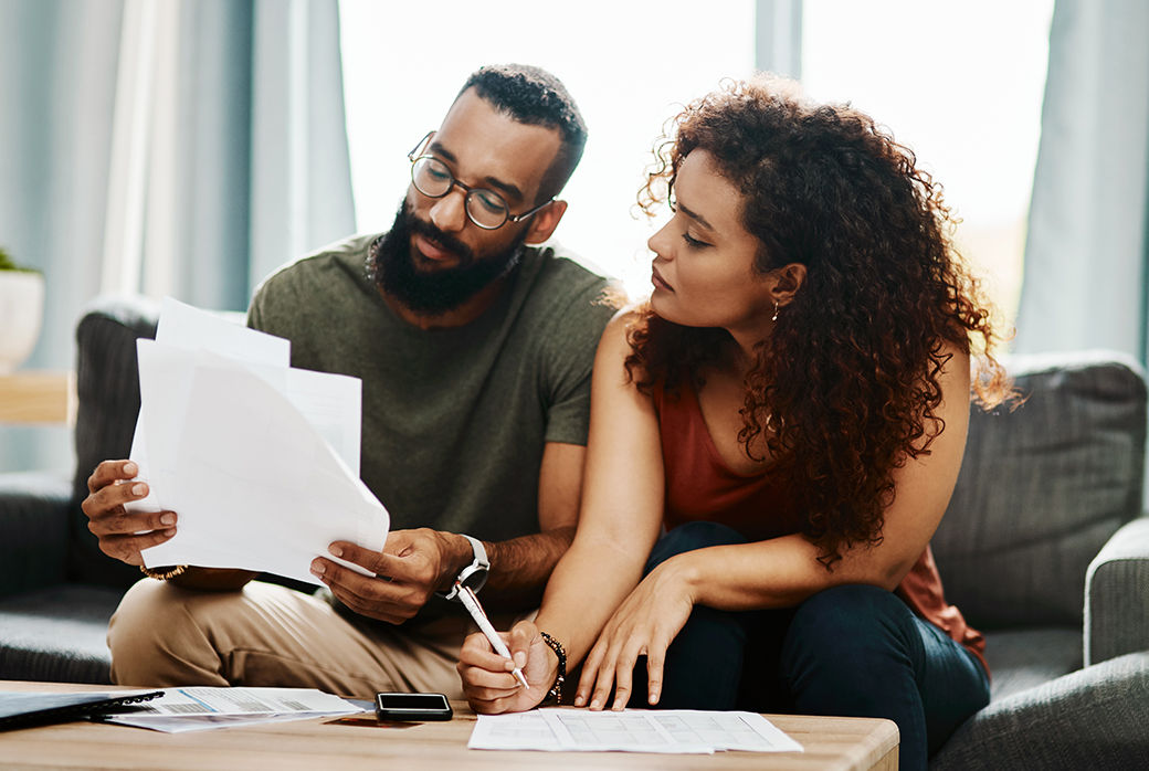 Couple reviewing paperwork together at home