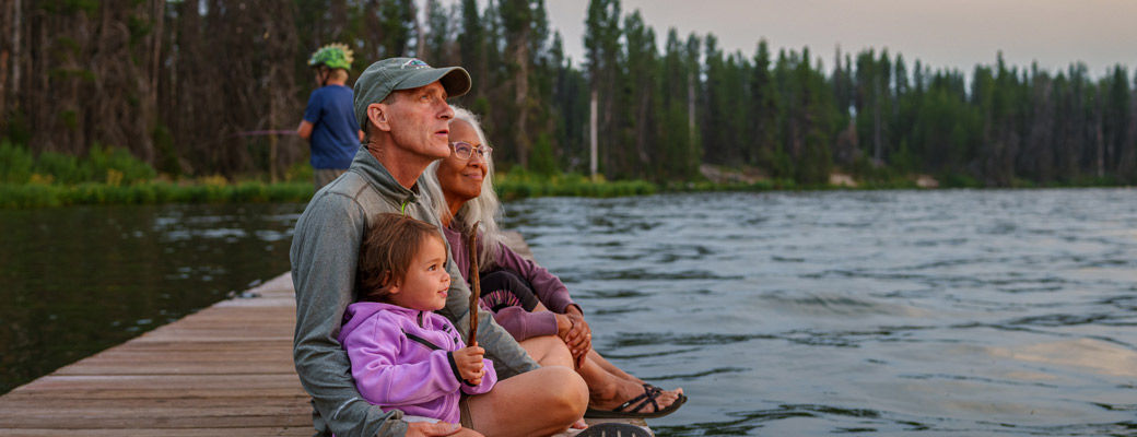 Family relaxing together at a lakeside destination
