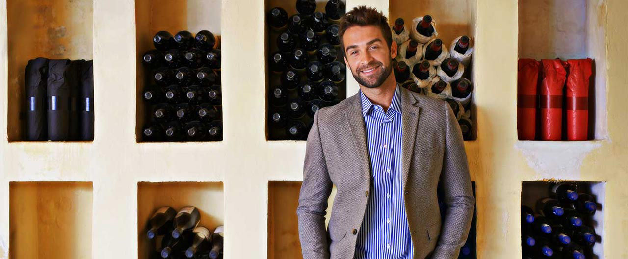 guy in front of wine collection