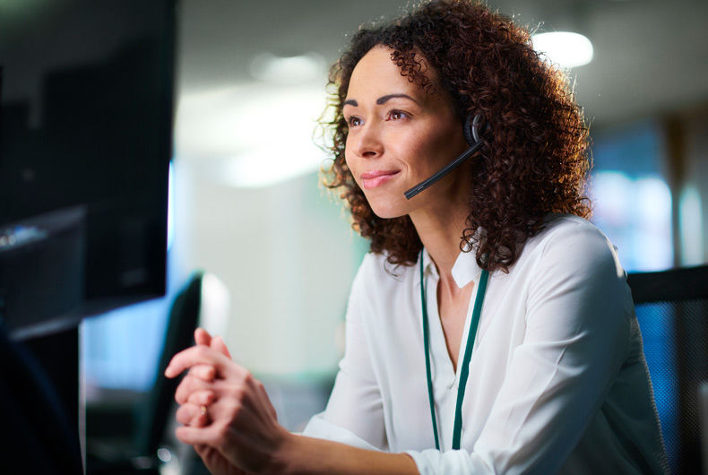 Customer service representative wearing a headset and providing phone assistance