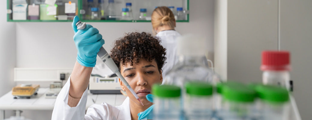 scientist pipetting
