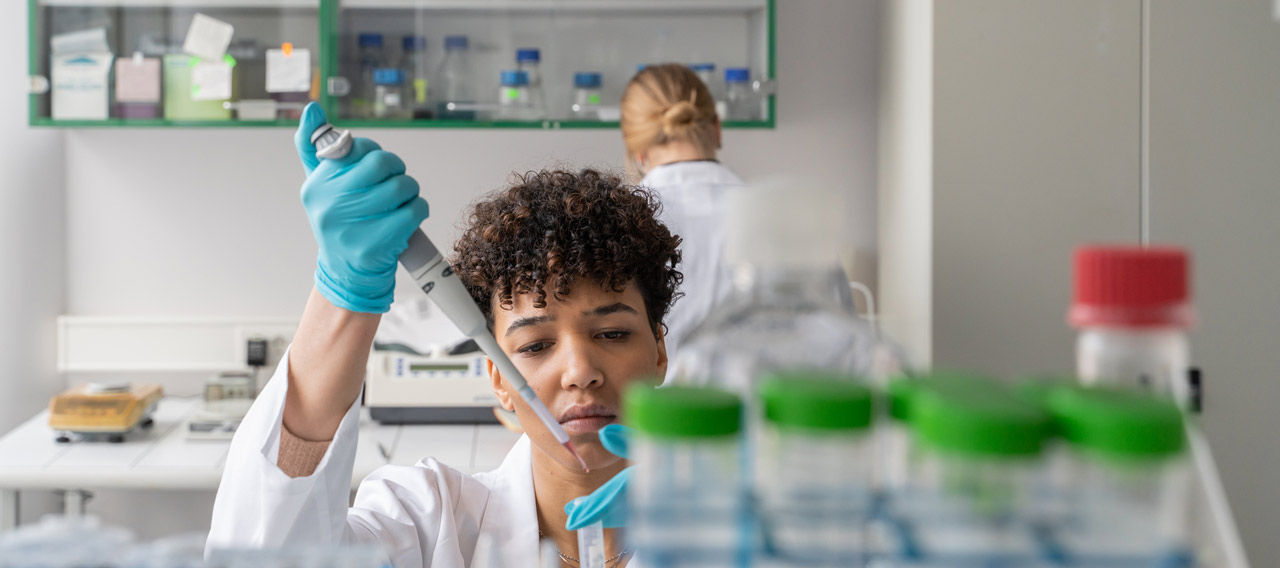 scientist pipetting