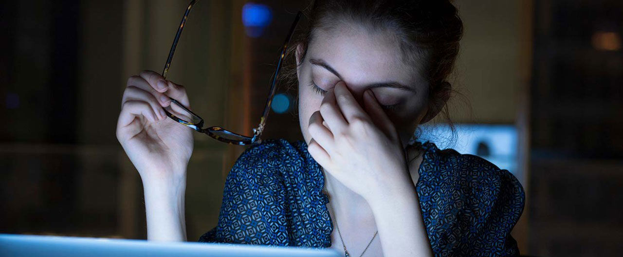 tired woman on computer