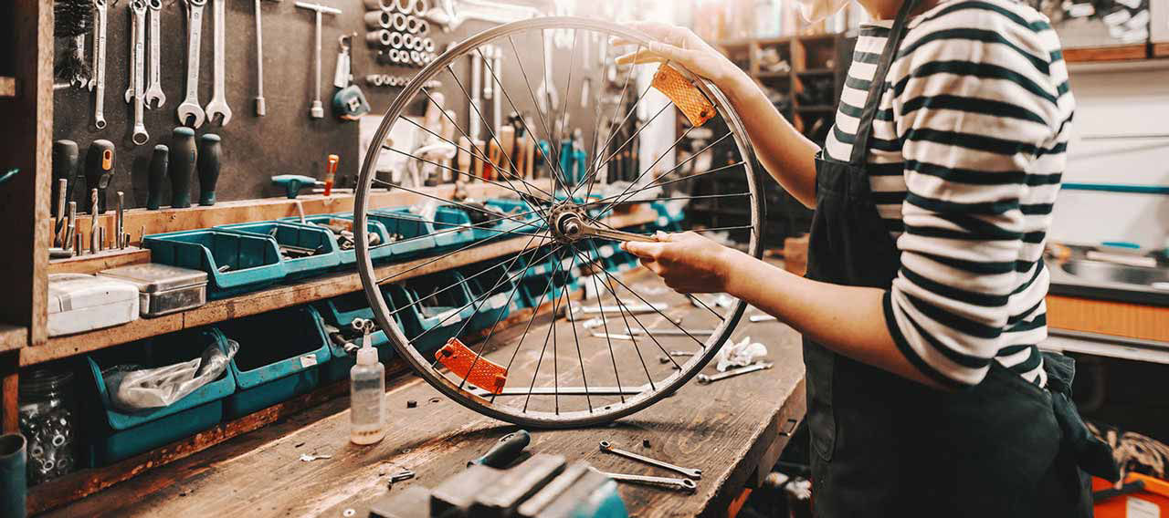 woman doing bike shop repair