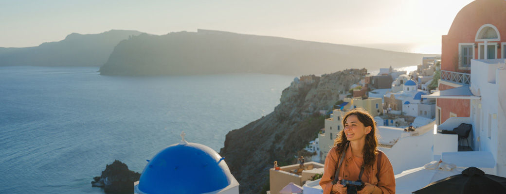 Woman exploring a coastal destination with a camera